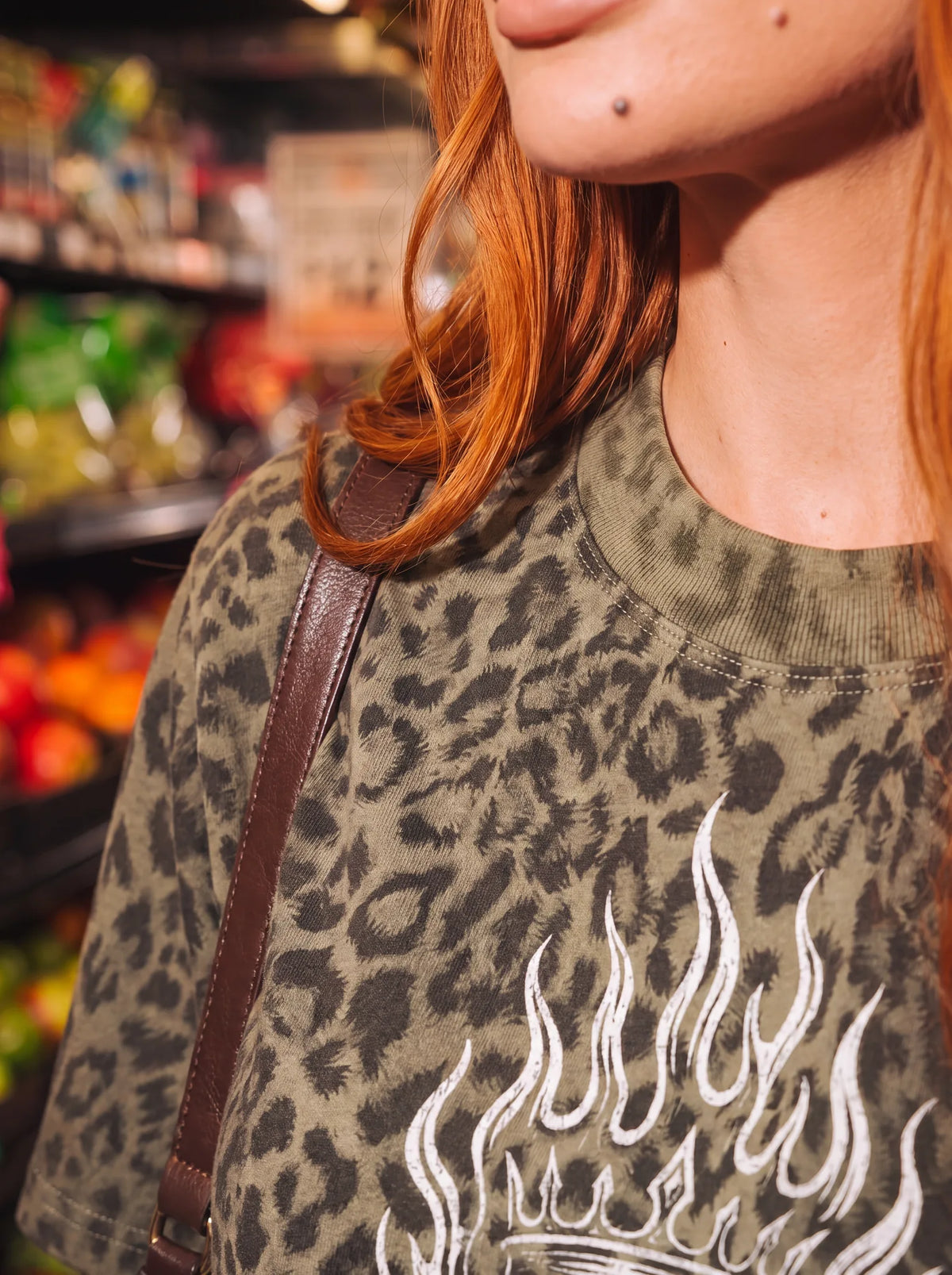 Neckline and flaming heel print on the "well behaved." leopard boxy tee