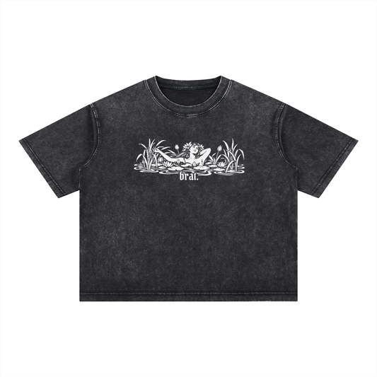 Black "brat." mineral wash boxy tee with a woman lounging in a lily pond print